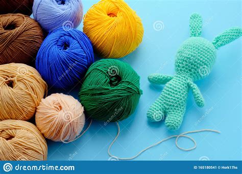 Bright Color Yarn Clews With Pastel Green Stuffed Bunny On The Blue