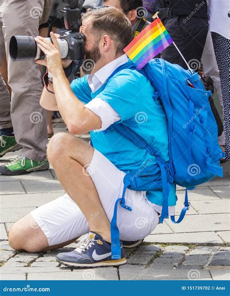 A Handsome Older Photographer With A Rainbow Flag Attending The Gay