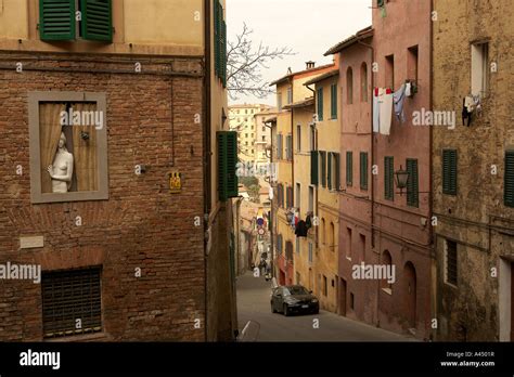 Naked Statue Of A Women Looking Out Of A Window In The Back Streets Of Siena Stock Photo Alamy