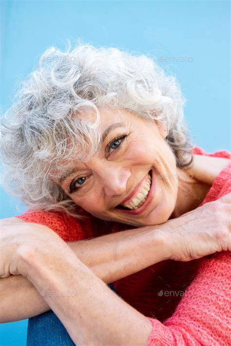 Close Up Smiling Older Woman Against Blue Background Stock Photo By