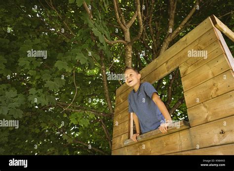 Happy Boy Looking Through Window In Playground Stock Photo Alamy