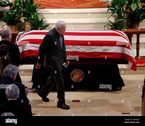 Former President Jimmy Carter Walks Past The Casket After Speaking At A