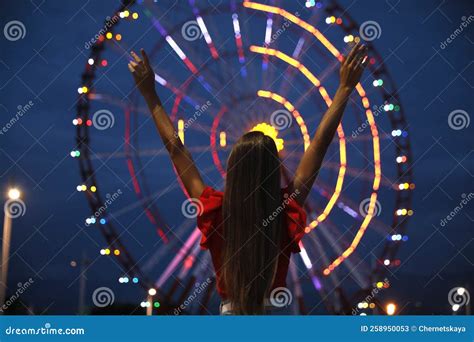 Beautiful Young Woman Against Glowing Ferris Wheel In Amusement Park Back View Stock Image