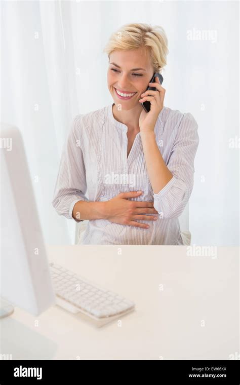 Smiling Blonde Woman Using Computer And Phoning Stock Photo Alamy