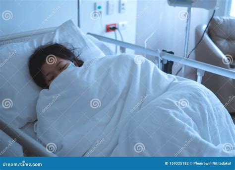 Asian Female Patient Sleeping On Hospital Bed To Recovering Sickness