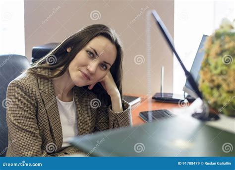 Front View Of Business Woman Sitting By The Table In Office And Looking At Camera Stock Image