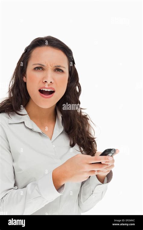 Portrait Of A Brunette Frowning While Using Her Mobile Stock Photo Alamy