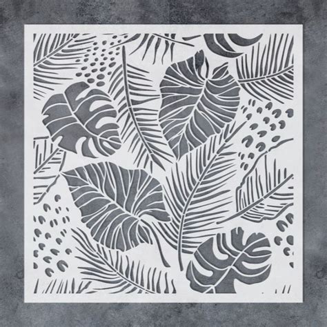 A Stencil With Leaves And Berries On It In Black And White Colors