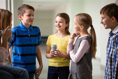 Group Of School Kids With Soda Cans In Corridor Stock Photo Image