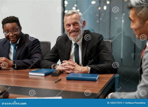 Portrait Of Cheerful Mature Businessman In Formal Wear Looking At