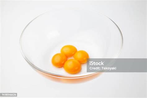 4 Egg Yolks In Glass Bowl Isolated On White Background Stock Photo