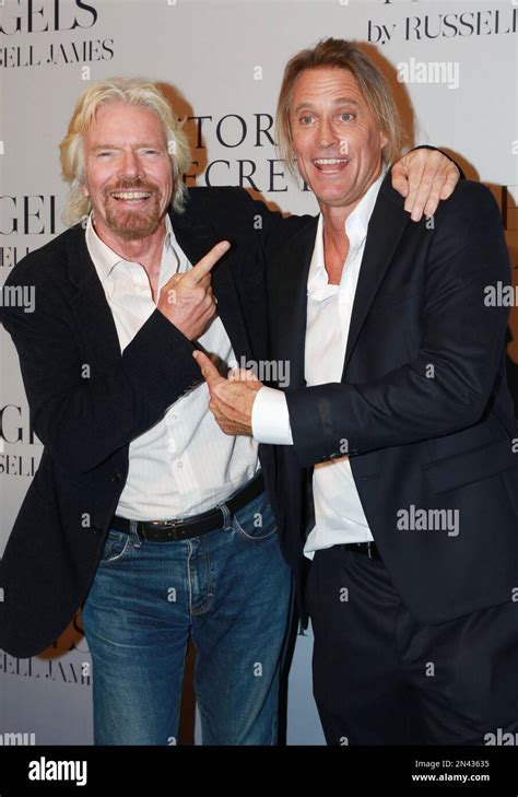 Richard Branson Left And Photographer Russell James Pose At A Gallery