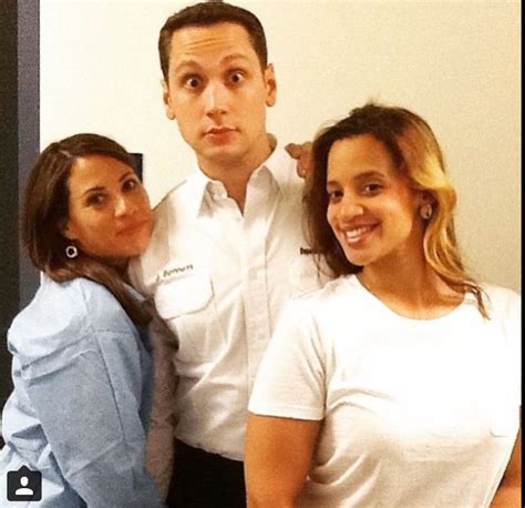 Two Women And A Man Posing For The Camera