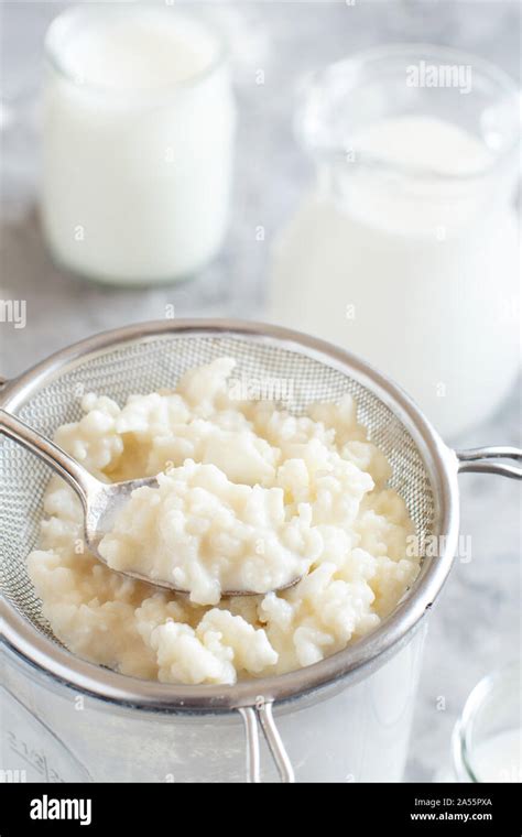 Kefir grains and fermented drink kefir close up Stock Photo - Alamy