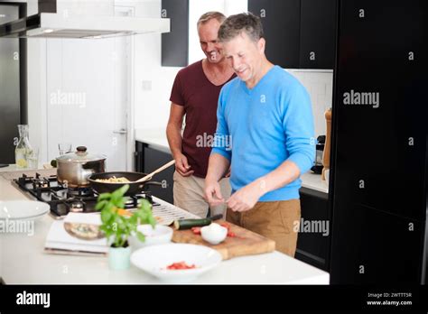 Two Men Cooking Together In A Modern Kitchen Stock Photo Alamy