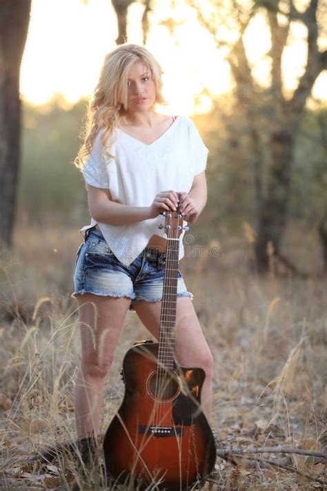 Country Girl Playing Acoustic Guitar In River Stock Image Image Of