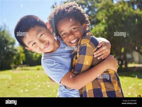 Portrait, children and friends hugging in a park together for fun, bonding or playing in summer ...