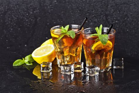 Two Glasses With Traditional Iced Tea With Lemon Mint Leaves And Ice