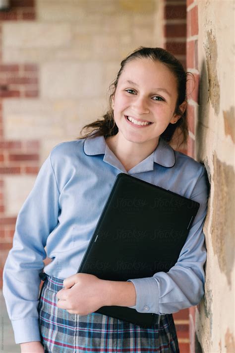 High School Student In Uniform Outside A Stone Building Del