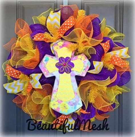 A Wreath With A Cross On It And Orange Yellow And Purple Deco Mesh