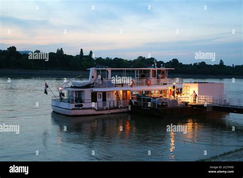 Tourist boat beside quay at night Stock Photo - Alamy