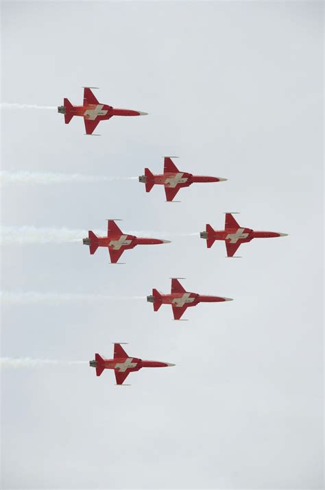 A Group Of Fighter Jets Flying Through A Cloudy Sky Photo Free