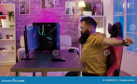 Bearded Man Sitting On Gaming Chair Stretching While Playing Video Games Stock Image Image Of