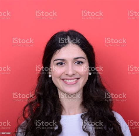 Portrait Of Beautiful Young Woman Smiling Against Red Background Stock