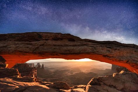 A Rare Image Of The Milky Way And The Rising Moon Lighting Up The Desert Landscape Below Mesa