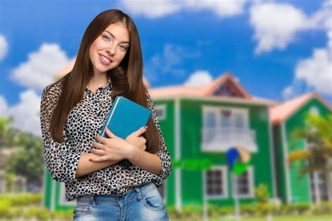 Premium Photo Smiling Business Woman Holding Stack Of Books