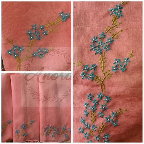 Some Blue Flowers On Pink Fabric With Green Stems And Leaves In The