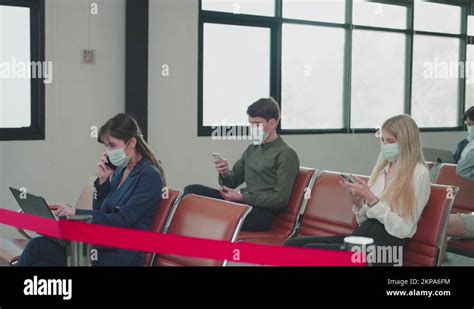 Airline Passengers Wear Face Masks While Waiting For Check In At The