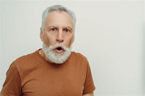 Premium Photo Amazed Shocked Senior Man Wearing Brown T Shirt Looking