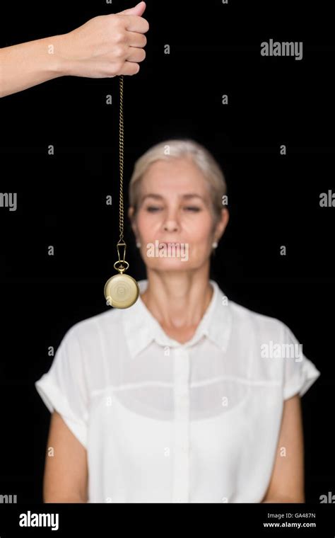 Cropped Image Of Hypnotherapist Holding Pendulum Before Woman Stock