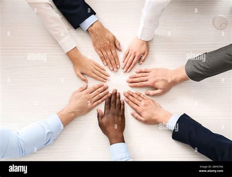 Group Of Business People Putting Hands Together In Office Top View