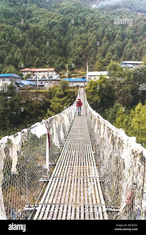 Bridge Over The River Solo Trekker On The Suspension Bridge In Nepal