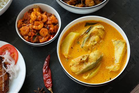 Kerala fish curry coconut milk gravy , cooking spicy Goan fish curry ...