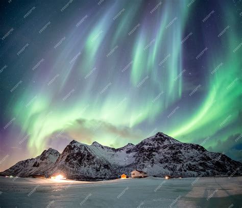 Premium Photo | Northern lights over mountain in winter