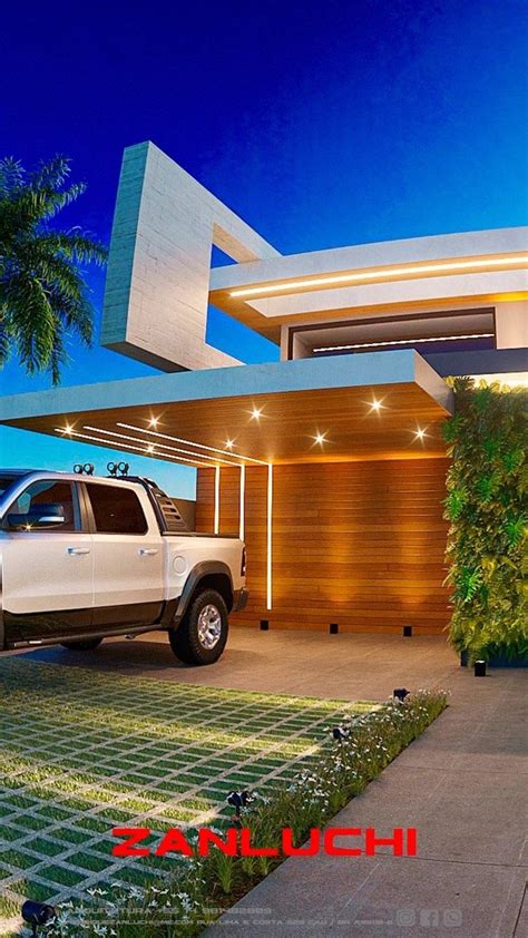 A White Truck Is Parked In Front Of A Modern House At Night With Palm Trees