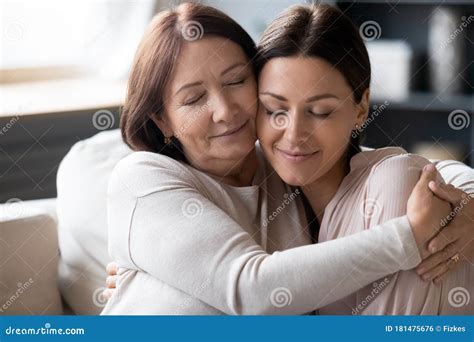 Mature Mother And Adult Daughter Hugging Enjoying Tender Moment Stock