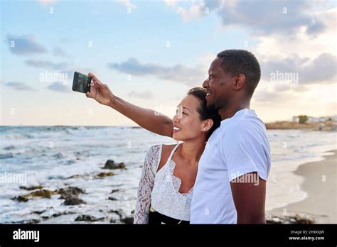 Happy Couple In Love Taking Selfie Together On Smartphone On Beach