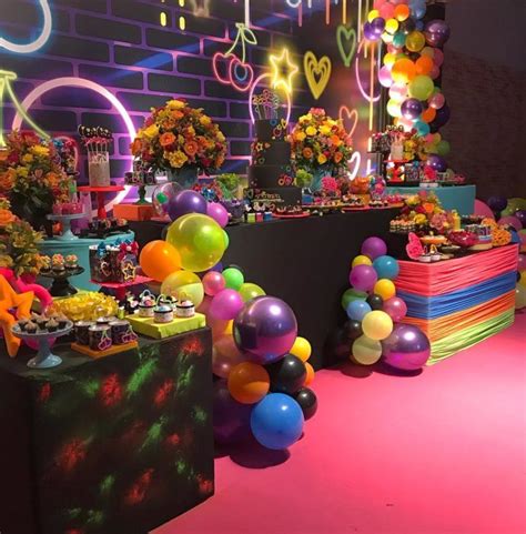 A Room Filled With Lots Of Colorful Balloons And Cake On Top Of Its Tables