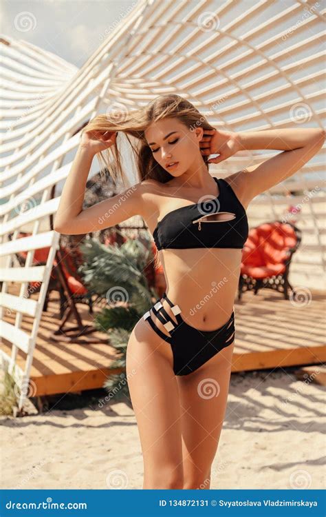 Beautiful Girl With Blond Hair In Elegant Swimming Suit Posing In