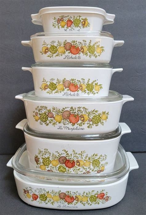 Four Casserole Dishes Stacked On Top Of Each Other With Fruits And