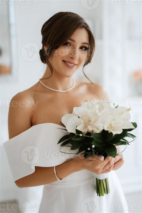 Brunette Bride In A Tight Wedding Dress In A Bright Studio Stock Photo At Vecteezy