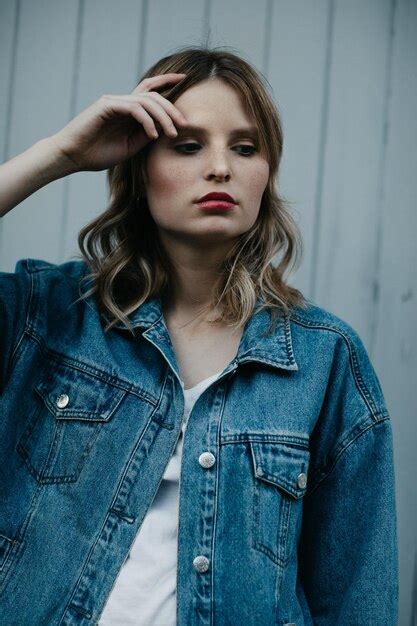 Premium Photo Thoughtful Woman Wearing Denim Jacket While Standing