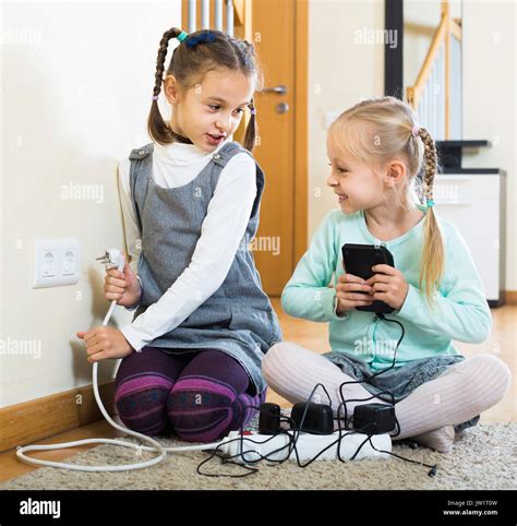 Little European Children Playing With Sockets And Electricity Indoors