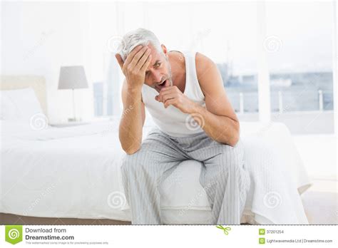 Thoughtful Mature Man Yawning In Bed Stock Photo Image Of Sleepy