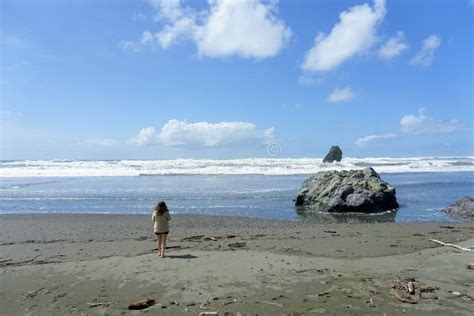 A Young Woman Beside Kissing Rock Along The Oregon Coast Highway On