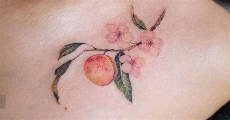 Peach And Blossom Tattoo Located On The Collarbone